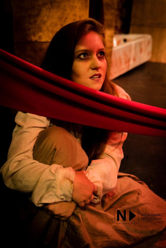 Jane Maridova (Lana Whittington) is forced into complicity in the Blood Ritual. Costume by Delena Bradley. Lighting by Benjamin Dionysus. Photo by iNDie Grant Productions